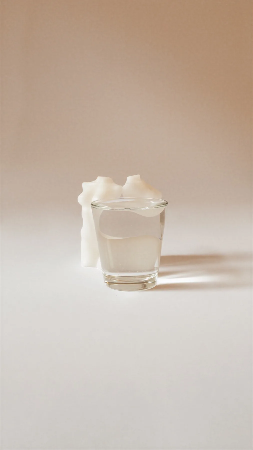 Distortion — a single body candle behind a glass of water