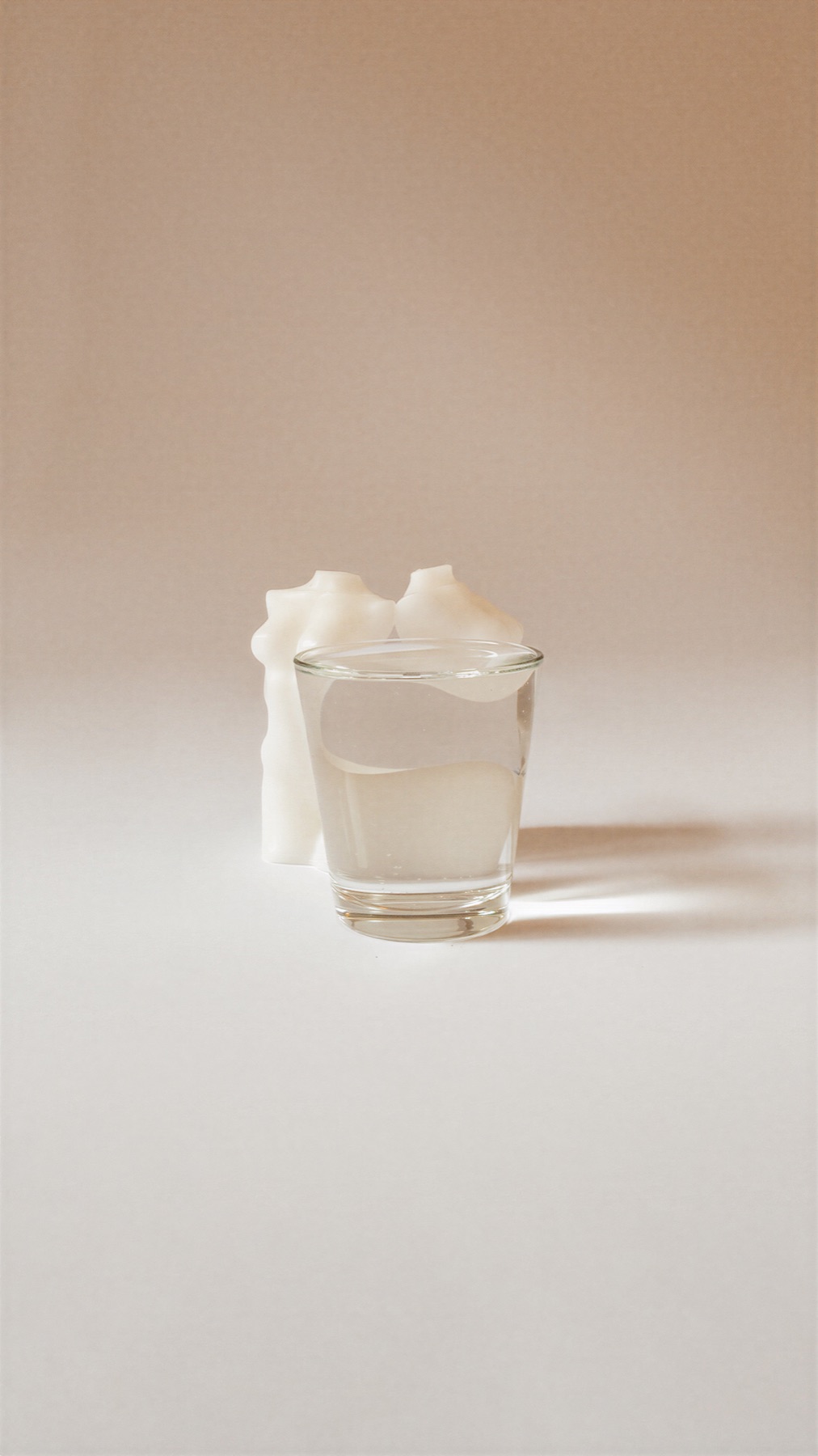 Distortion — a single body candle behind a glass of water